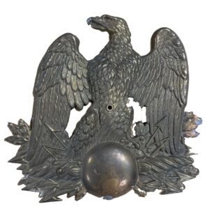 Antique pressed copper ornament in the form of an eagle with globe and arrows
